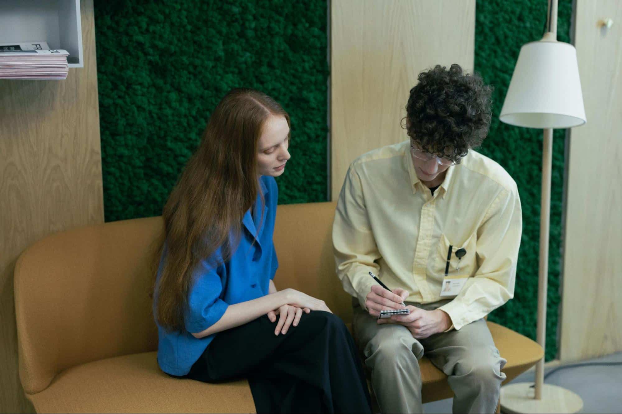 A man and woman sitting at the sofa 