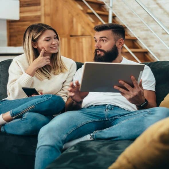 A couple looking at something on the tablet