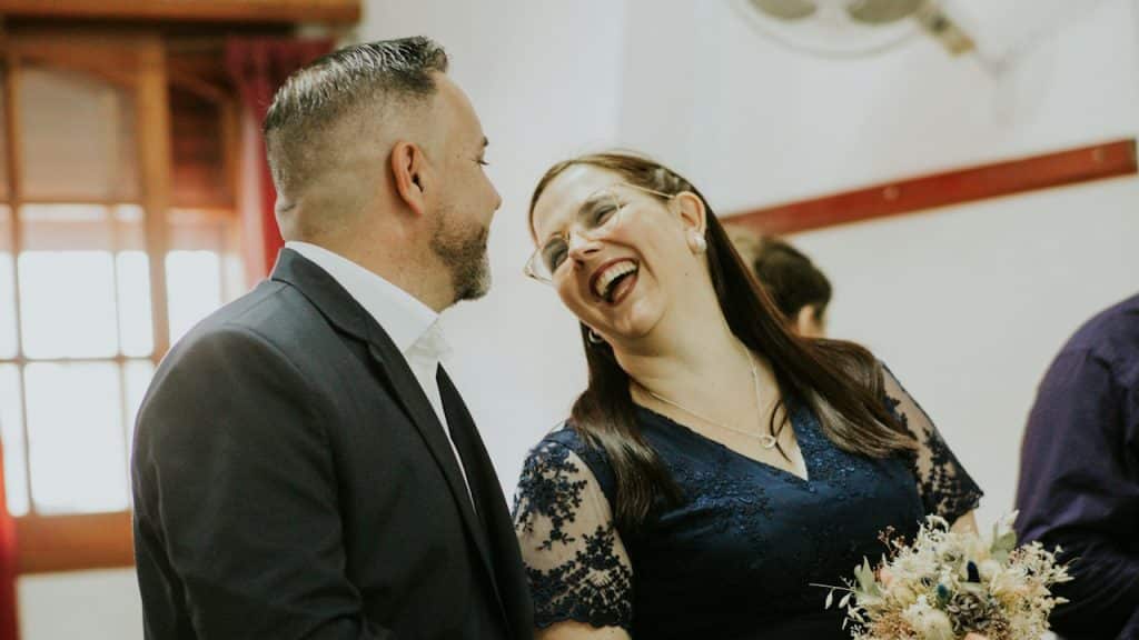 A man and a woman laughing together.