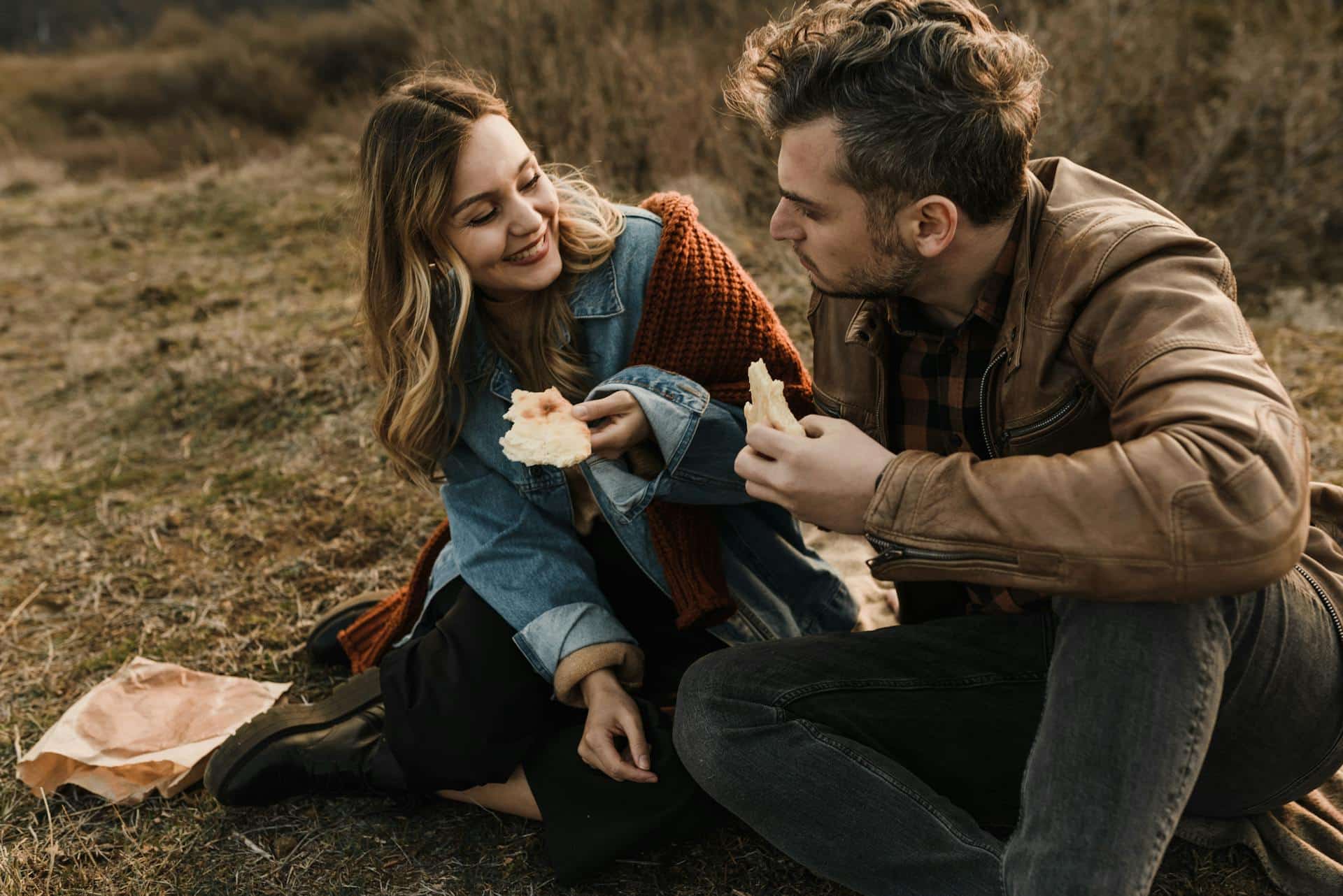A couple sitting and looking at each other.