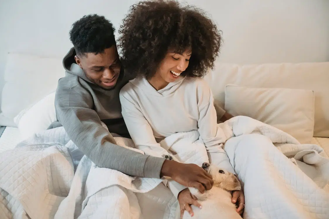 A man and a woman with a dog