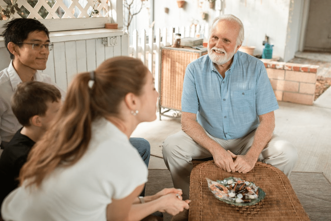 An old man talking to a young woman