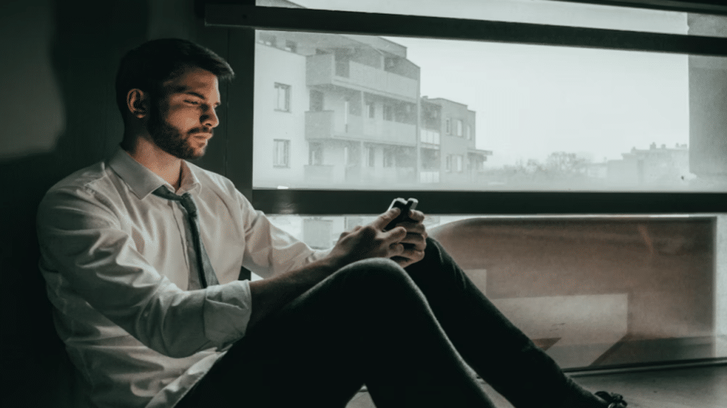 A man looking sad while texting