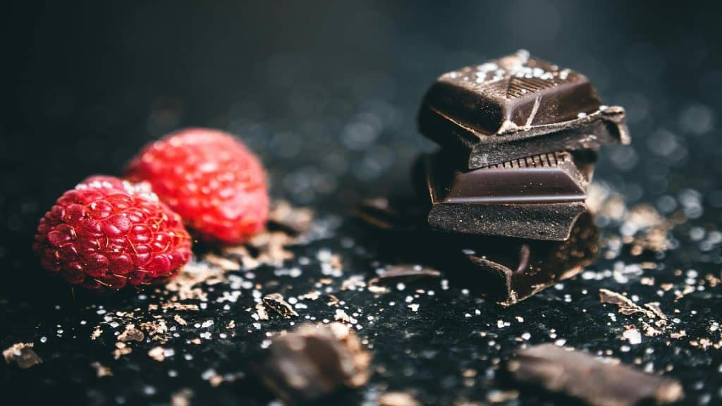A closeup photo of berries and chocolates