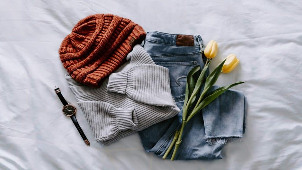A casual outfit laid on a bed
