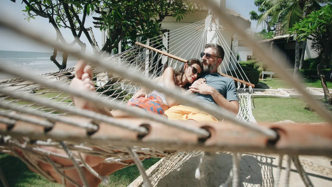 A couple relaxing on a hammock