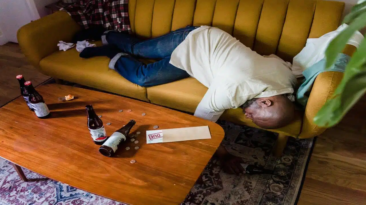 A drunk man sleeping on the couch