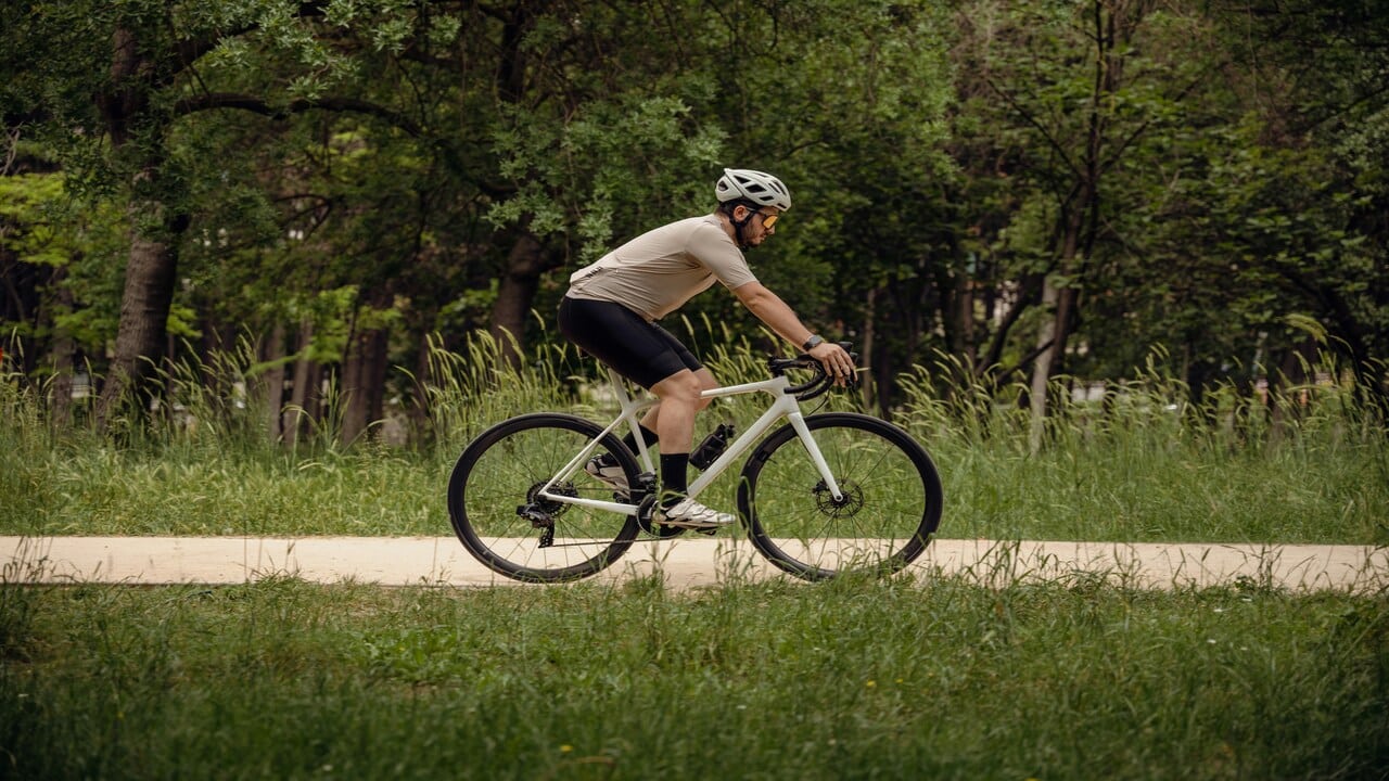 A man cycling down a dirt road