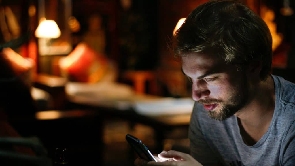 A man sending text on his cell phone.