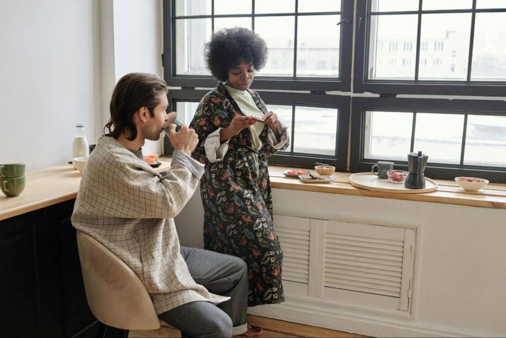 A man and woman beside the window
