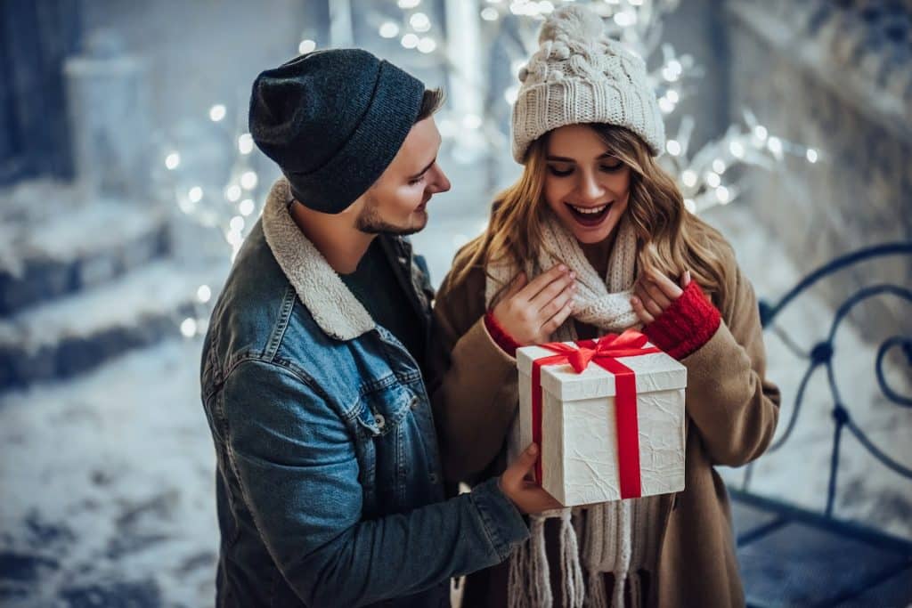 A man surprising the woman with a gift.