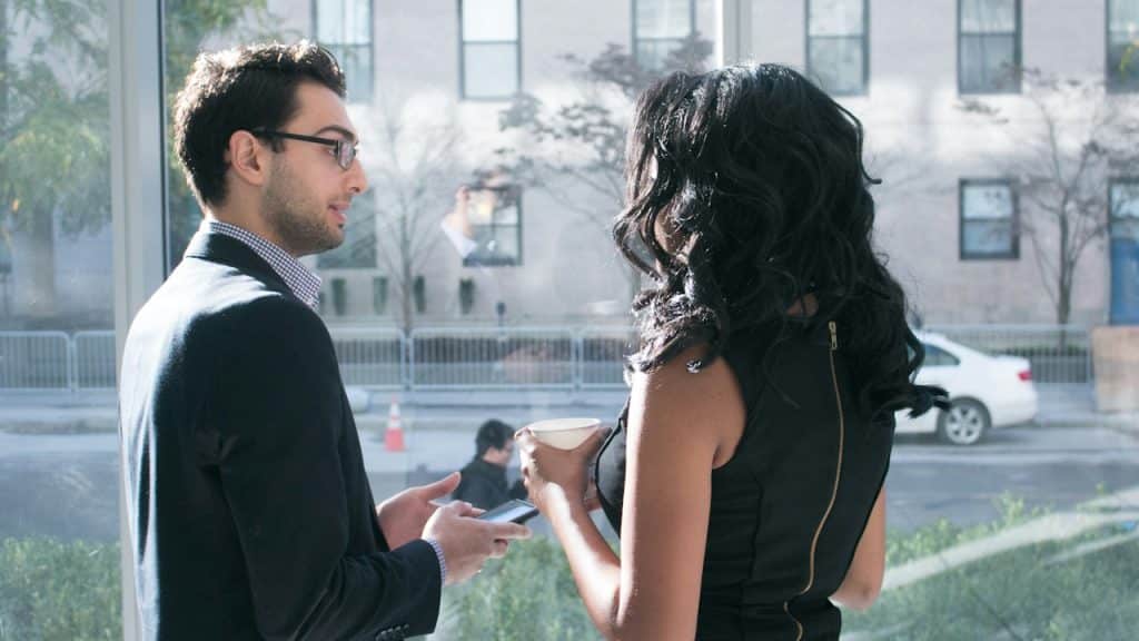 A man and a woman standing outdoors.