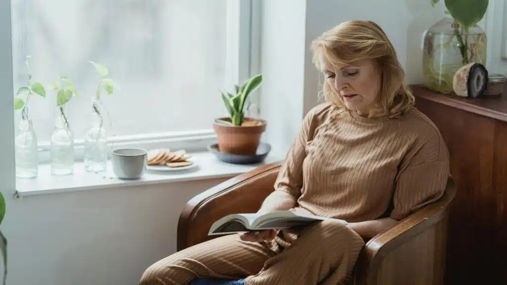 A woman reading a book at home