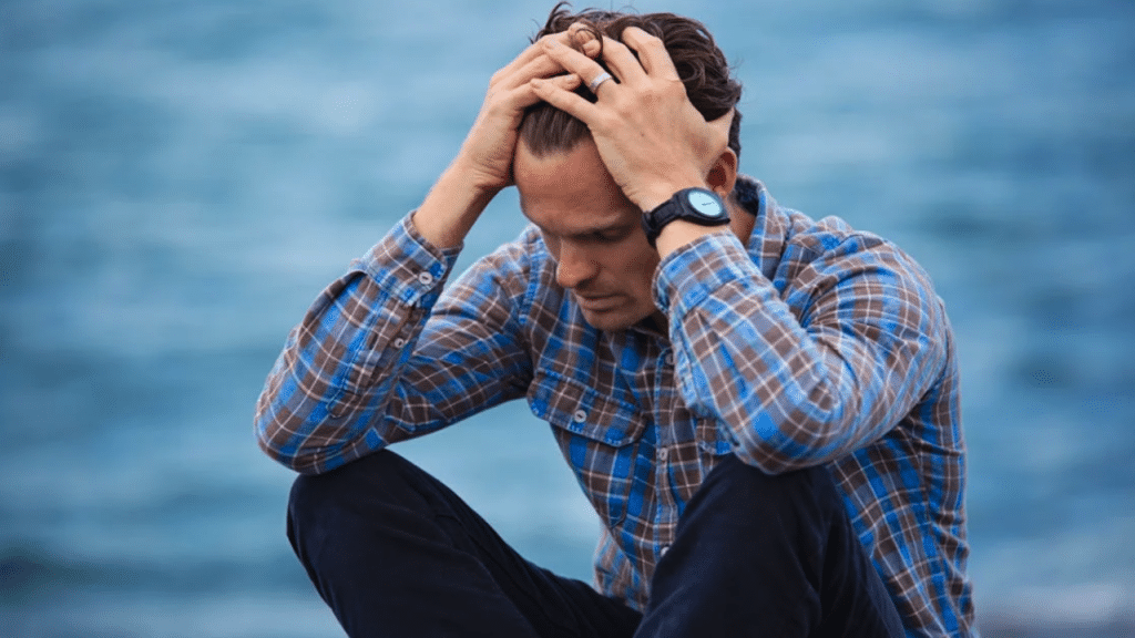 A man looking sad outdoors