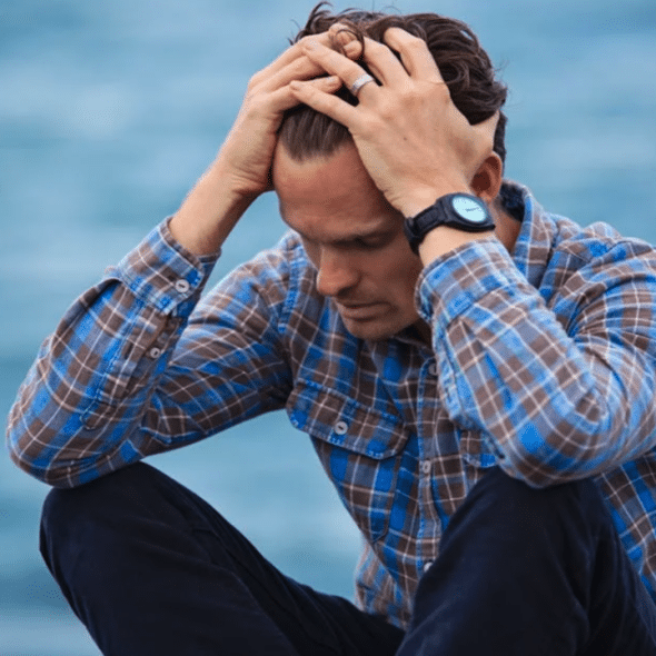 A man looking sad outdoors