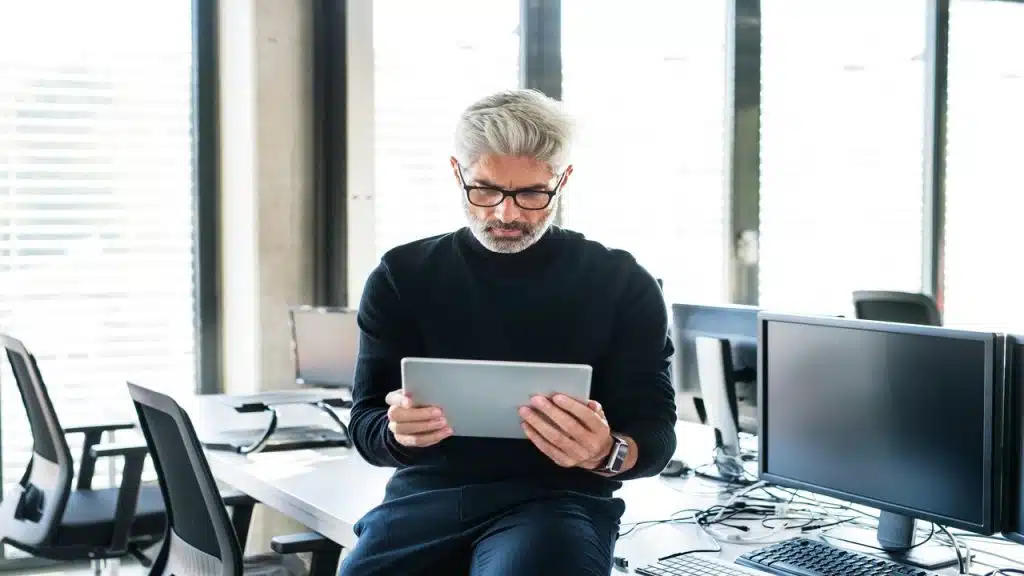 An older gentleman looking at his iPad