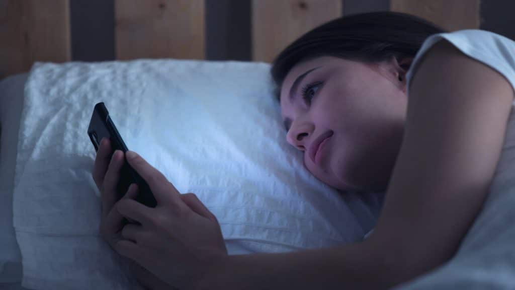 A woman looking sad while texting