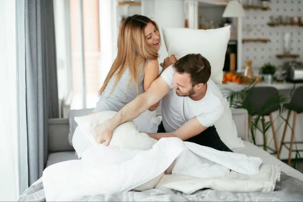 A man and woman at the bed
