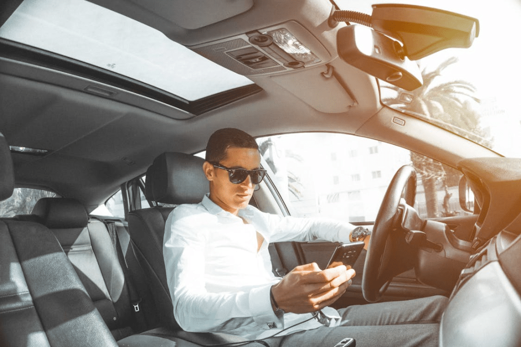 A man using his phone in a car