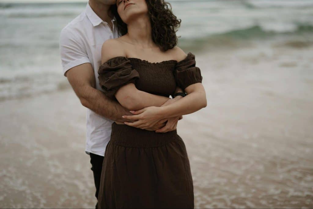 A man hugging a woman from behind