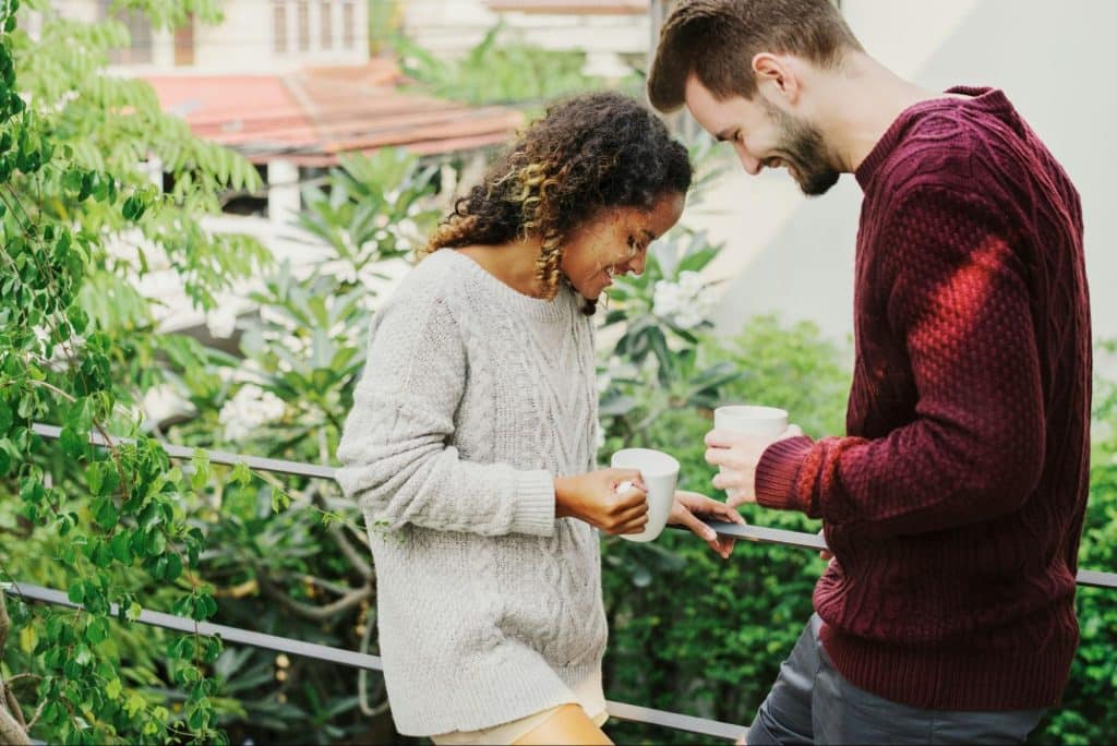 A man and woman having a cup of coffee