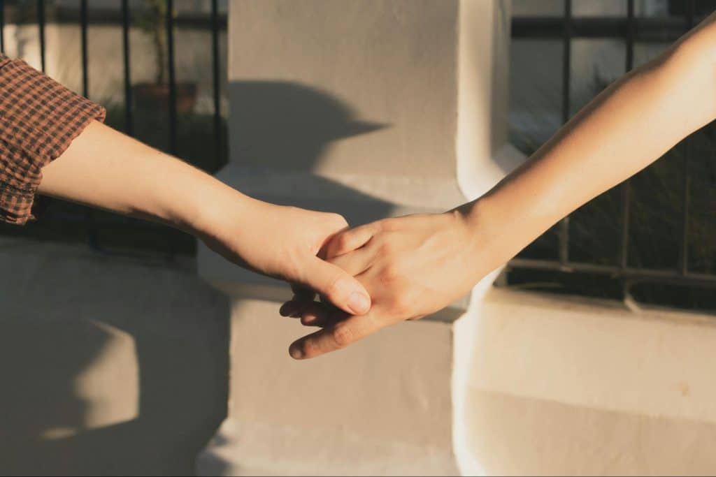 A man and woman holding hands