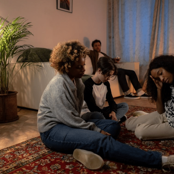 A Family Sitting on the Floor Having Problems