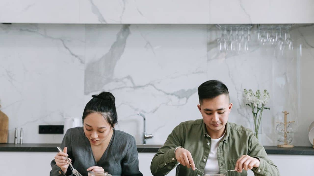 Couple silently eating dinner in routine