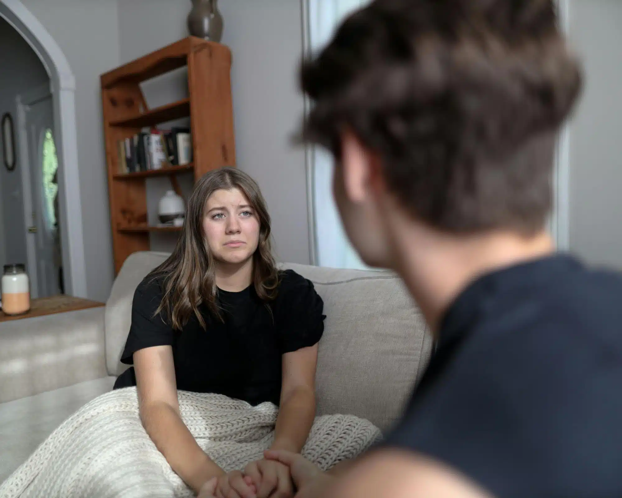 A sad woman in front of a man 
