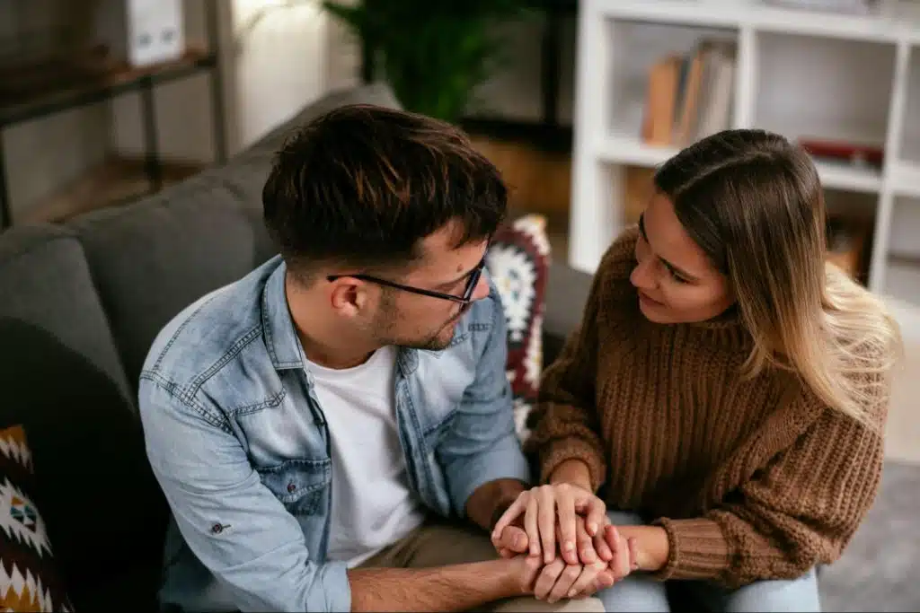 A man apologizing to woman