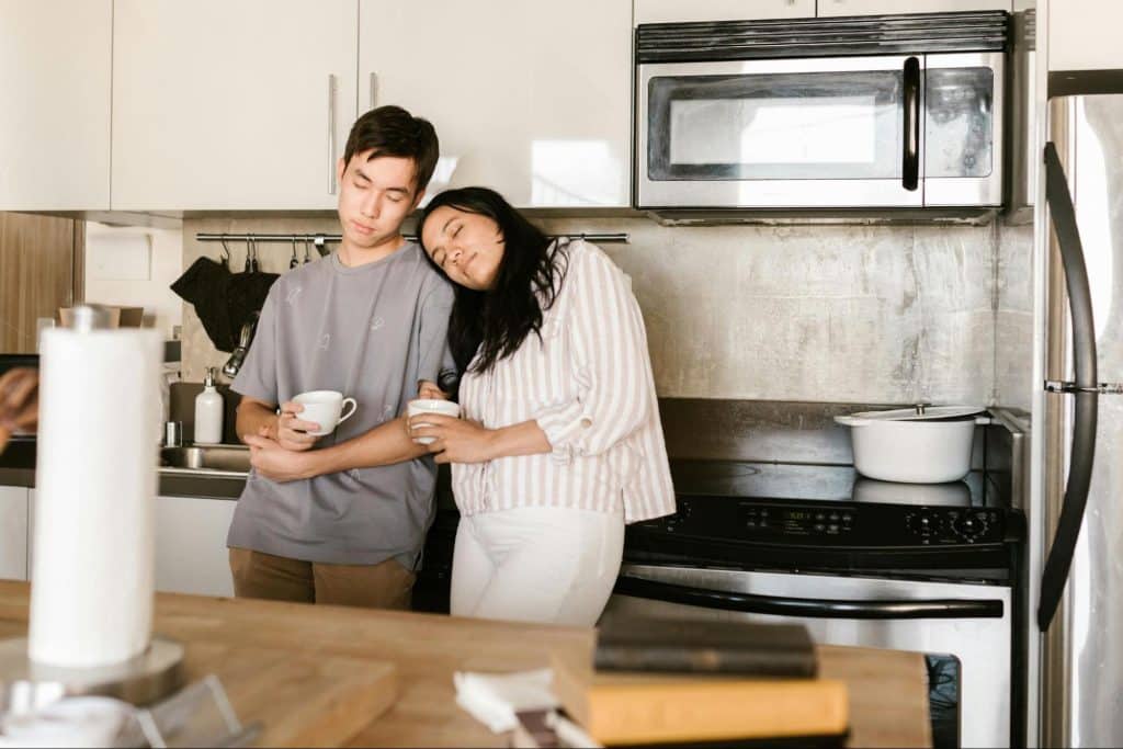A man and woman at the kitchen