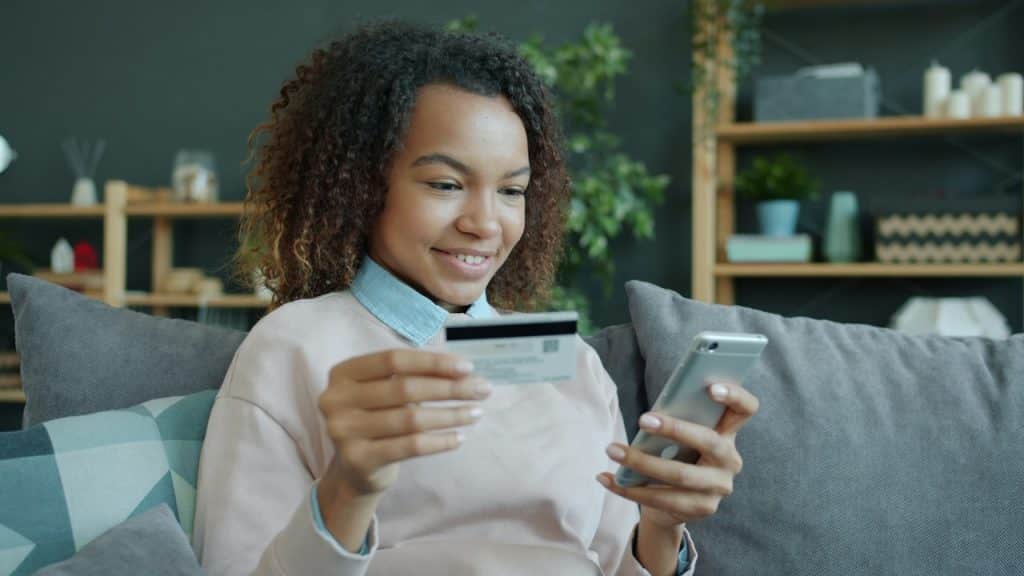 A woman paying bills from her debit card.