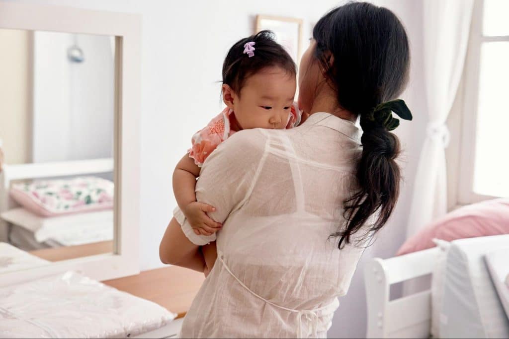 A woman carrying a child
