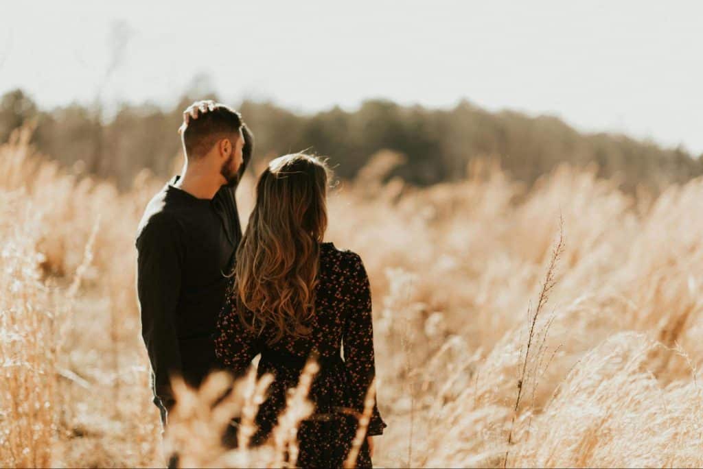 A man and woman at the grass field 
