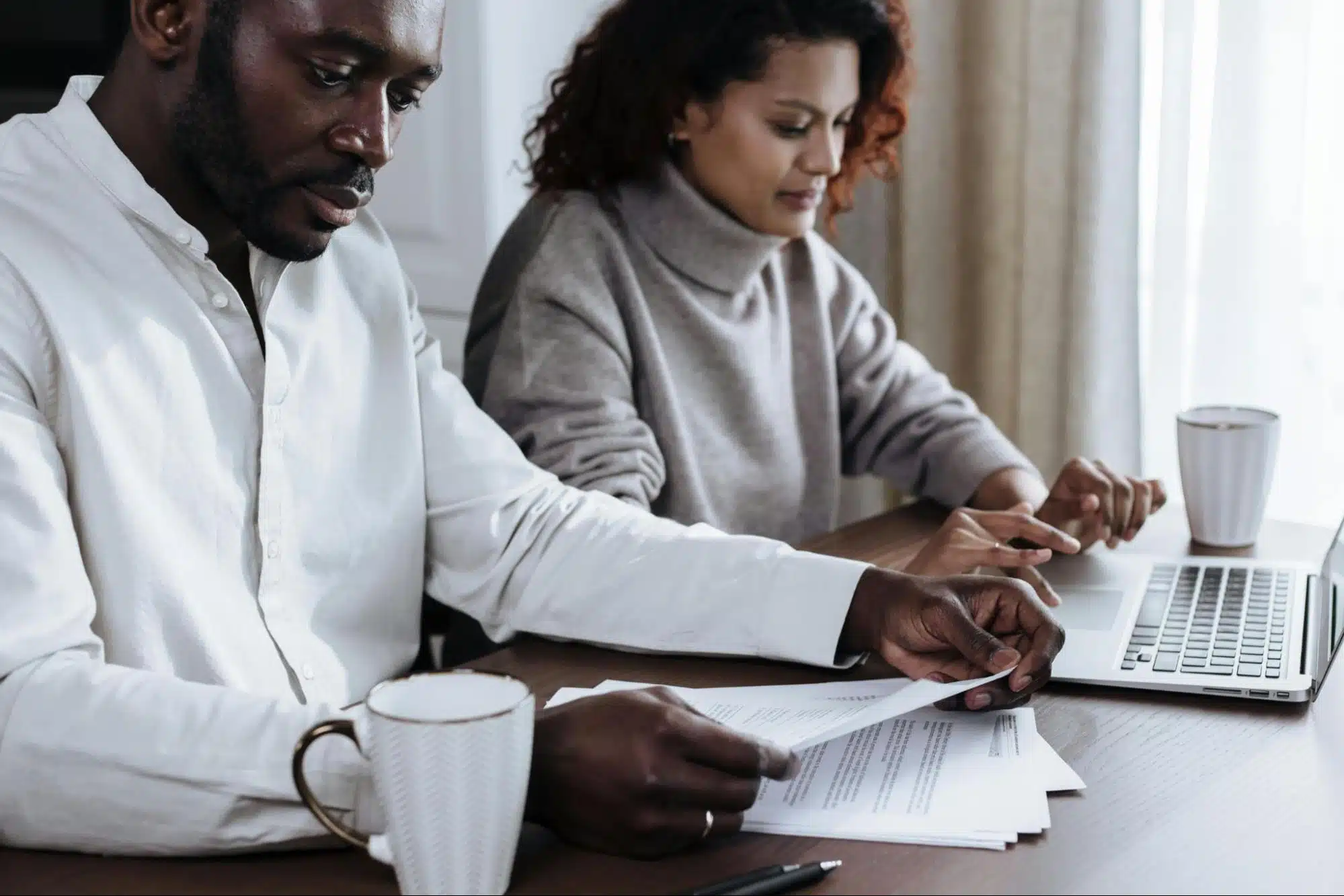 A man and woman busy with documents