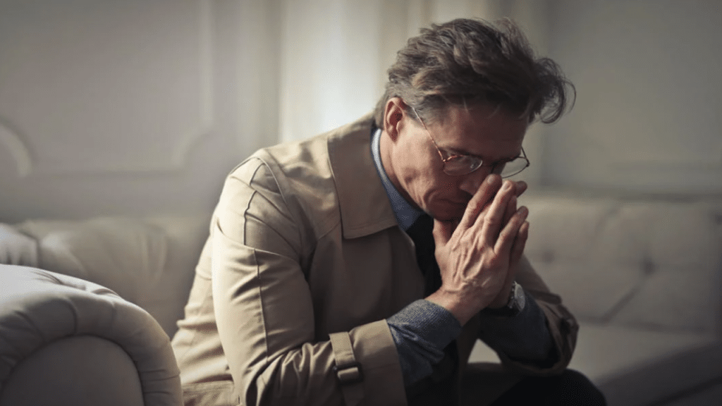 A man looking upset at home