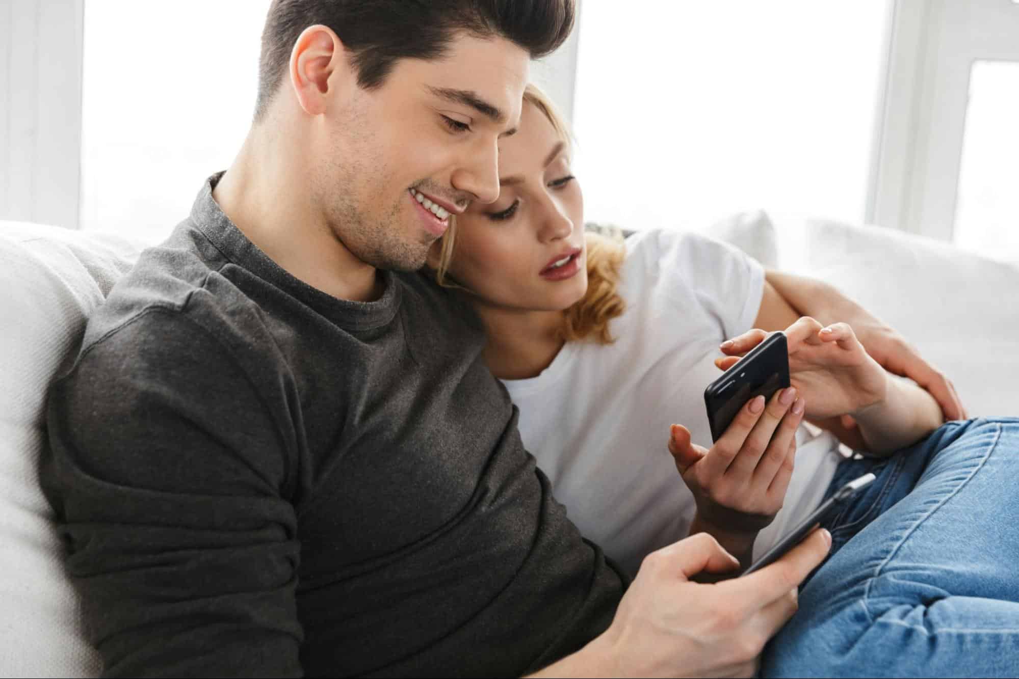 A man and woman busy with their phones