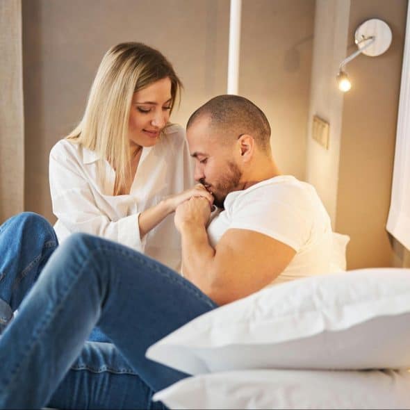A man kissing a woman’s hand