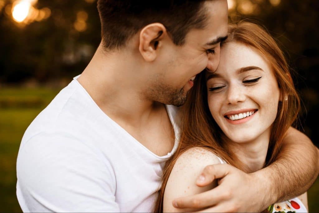 A man hugging  a woman