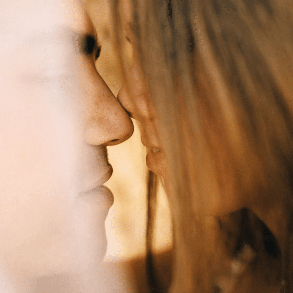 Close up photo of a couple kissing