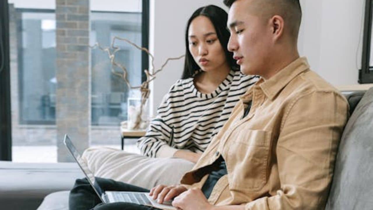 Husband prioritizing distractions while wife waits to connect