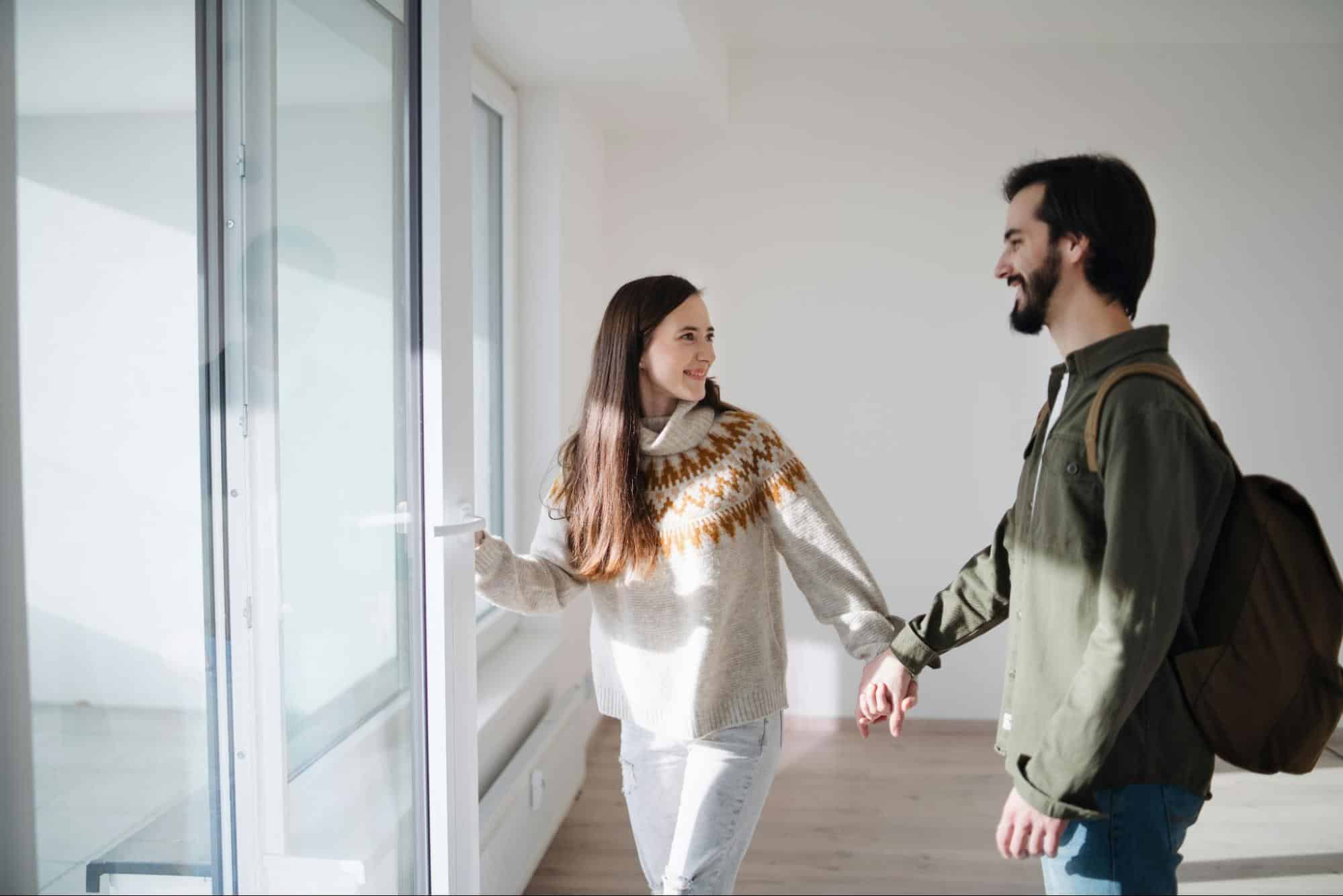 A woman holding the hands of a man 