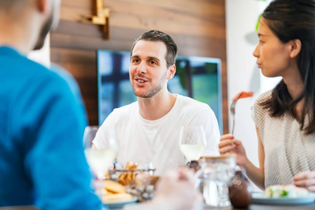 A man talking while having a house party.