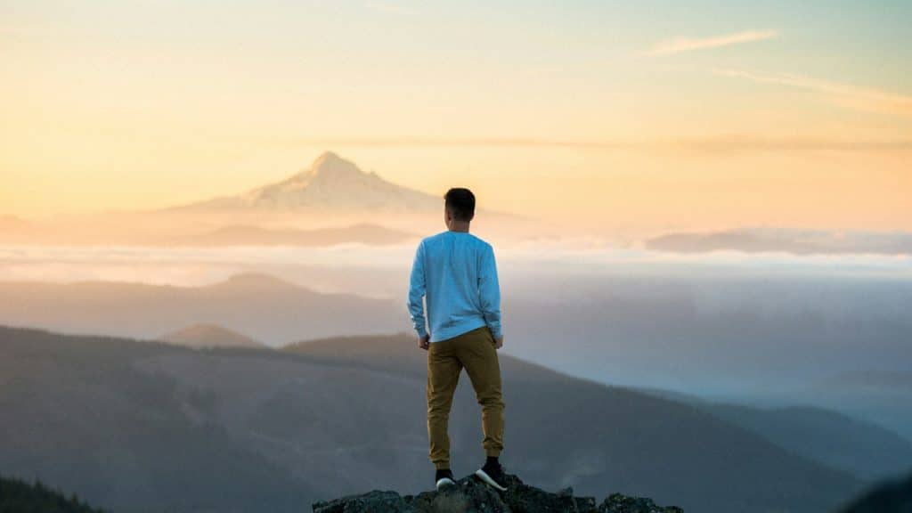 A man standing on top of a mountain.