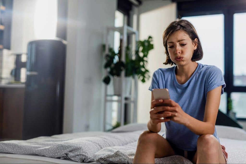 A woman crying while contacting her boyfriend