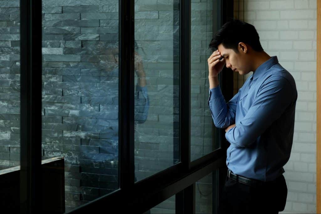 A man in front of a big window