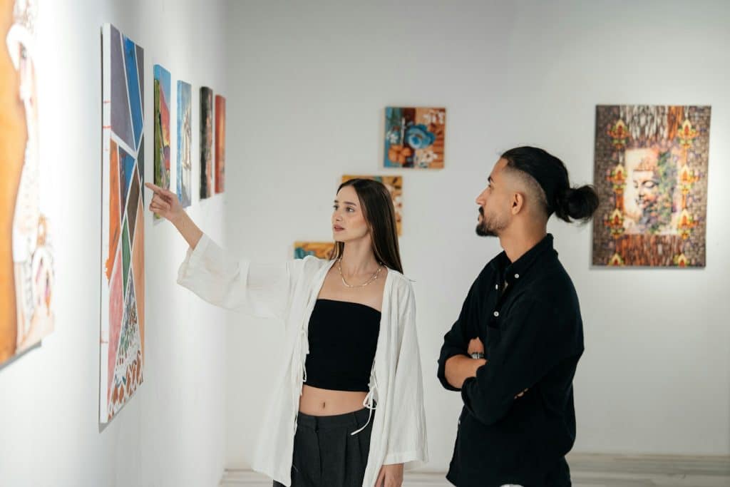 A man and a woman looking at an art in a gallery.