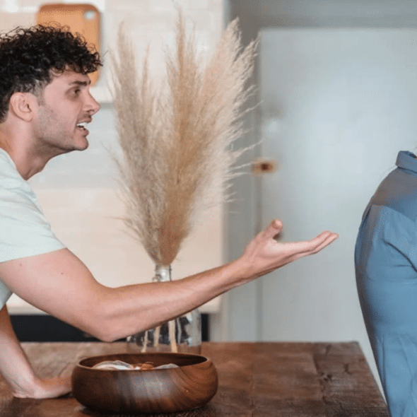 A couple fighting in the kitchen