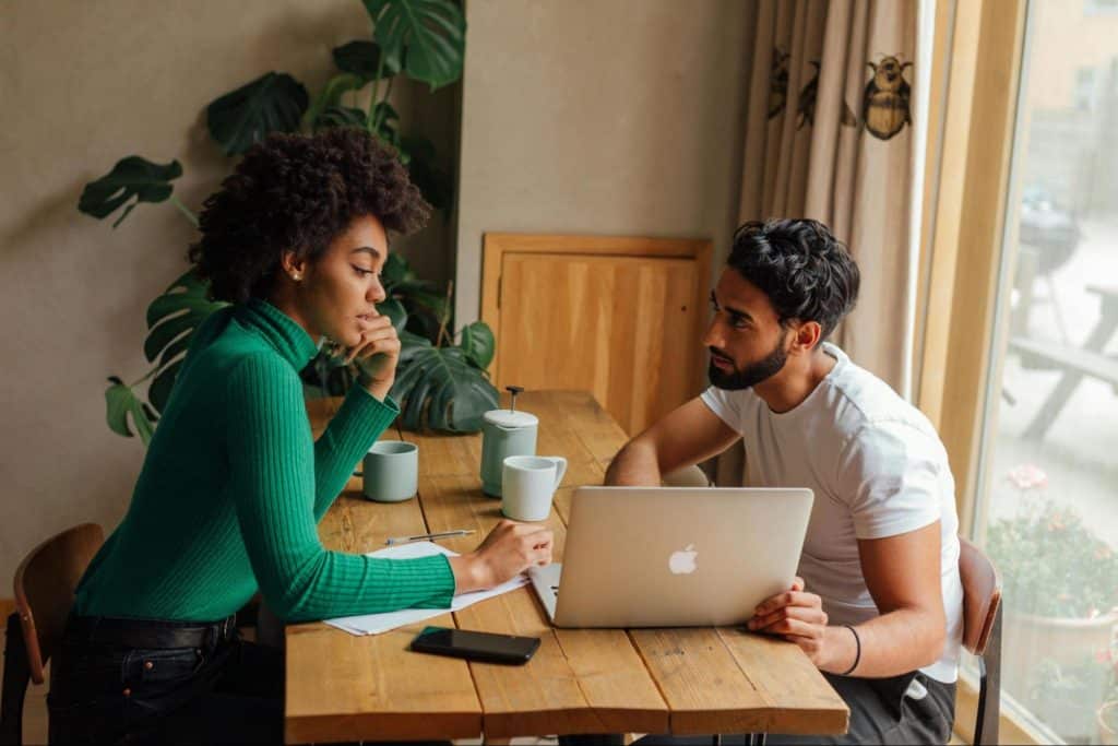 A man saying something to woman