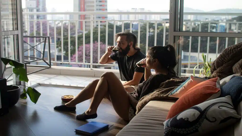 A couple having snacks together in the living room 